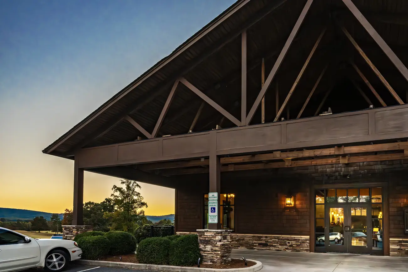 Front entrance of Brushy Mountain Event Center at sunset with mountain views beyond